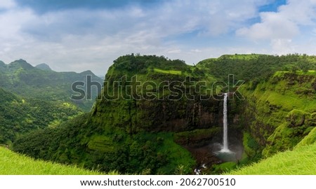 Beautiful waterfall with dramatic sky, somewhere in the Sahyadri ranges of western ghats of Maharashtra Royalty-Free Stock Photo #2062700510