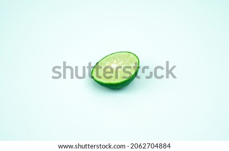 Green lime with cut in half isolated on white background.