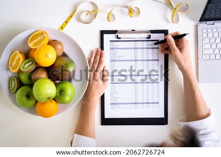 Female Nutritionist Or Dietitian In Laboratory Writing Royalty-Free Stock Photo #2062726724