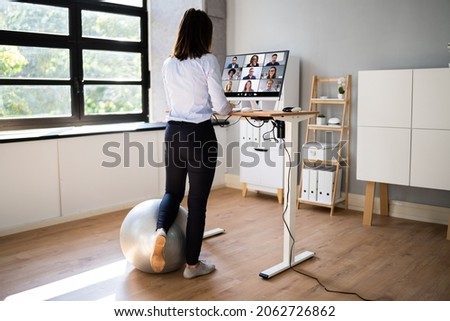 Video Conference Call Using Electric Adjustable Height Standing Desk Royalty-Free Stock Photo #2062726862