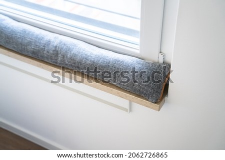 Draft Excluder Under Window Blocking Cold Air From Traveling Around Royalty-Free Stock Photo #2062726865