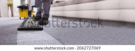 Professional Carpet Cleaning Service. Janitor Cleaner Removing Stains Royalty-Free Stock Photo #2062727069