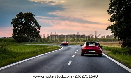 2 Sports cars on amazing winding district road - driving for fun. Mazda MX-5 ND RF. Miata. Amazing winding road. Green background HD. Wallpaper 4k. Royalty-Free Stock Photo #2062751540