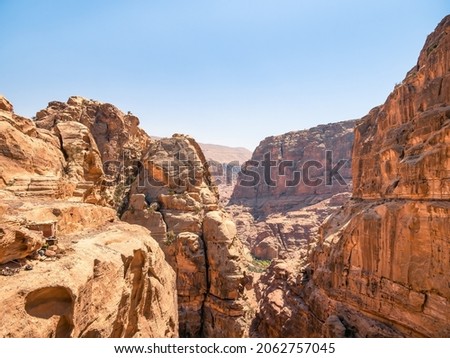 Mountain wall of red sand rock that surround the ancient city of Petra, Jordan. Rocky desesrt landscape