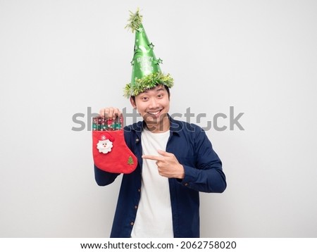 Man point finger at christmas stocking in his hand white background