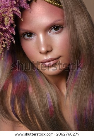 Portrait of beautiful woman with multi-colored hair and creative make up and hairstyle.