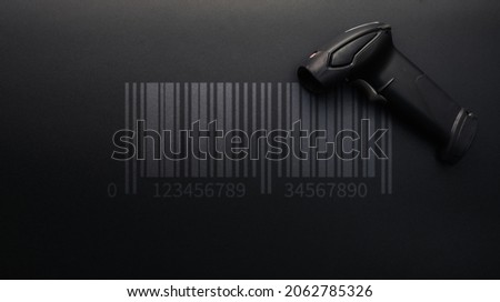 Barcode scanning. Reader laser scanner for warehouse. Retail label barcode scan on dark background. Warehouse inventory management Royalty-Free Stock Photo #2062785326