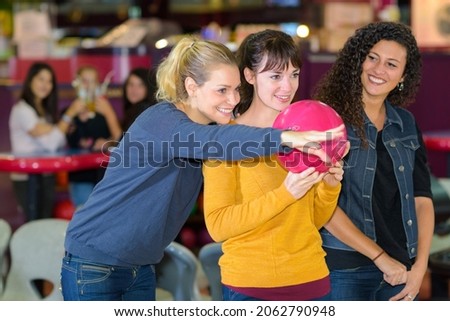 women trying to play bowling