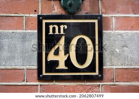 House number forty (40) engraved in a black plastic plate
