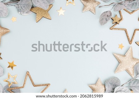 Festive pastel background. Christmas stars and shining glitter, confetti on pastel background. Christmas background, Flat lay.
