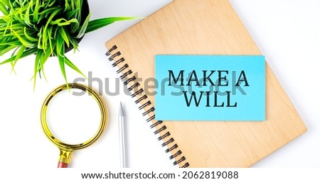 Notebook with Tools and Notes with text on blue sticker MAKE A WILL