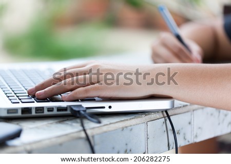 Graphic designer using digital tablet and computer at home office