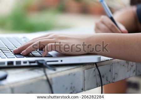 Graphic designer using digital tablet and computer at home office