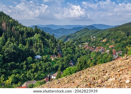 Scenic view of beautiful mountain village . Spania Dolina in Low Tatras, Slovakia. Small church, colorful house roofs and lush forest. Royalty-Free Stock Photo #2062823939