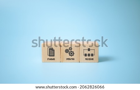 Standard Operating Procedure - SOP business concept. Instructions to assist employees in complex routine operations. The wooden cubes with "Standard Operating Procedure" symbols on blue background. Royalty-Free Stock Photo #2062826066