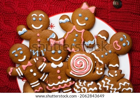 Smiling gingerbread mens nestled in holiday dish. Set of christmas homemade cookies