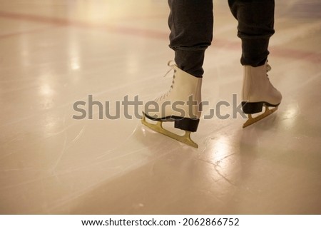 White skates on ice. The woman is sliding on the ice. Workout