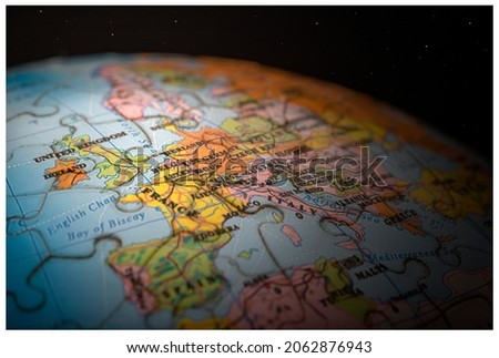 A closeup shot of a globe jigsaw, focussed on the United Kingdom and Western Europe.