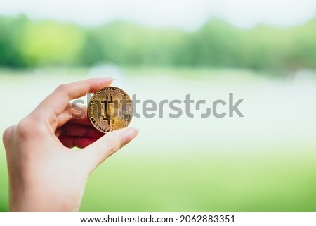 Woman hand holding golden bitcoin coin as the symbol of digital crypto currency, block chain, defi and decentralized finance exchange with copy space - Virtual currency money in the future concept
