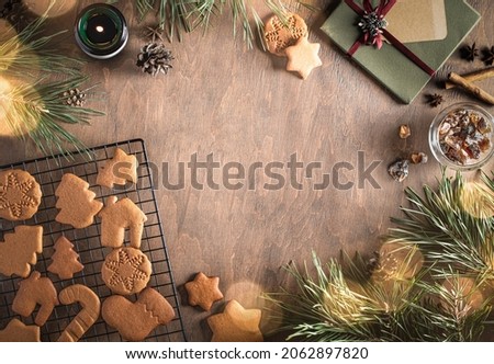 christmas composition with pine branches, lights and ginger cookies with space for the text. top view