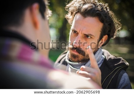 Close-up finger pointing of two very angry, nervous and upset men in an aggressive and fierce quarrel conflict on the verge of a physical confrontation and a fight. Concept of male conflict Royalty-Free Stock Photo #2062905698