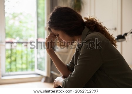 Worried frustrated young woman feeling depressed and lonely, suffering from stress and nervous breakdown after emotional trauma, needing psychological help. Depression, mental healthcare concept Royalty-Free Stock Photo #2062912997
