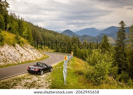 Sports car on winding alpine road (Zellerrain Pass, Zellerrain Strasse, Zellerrain Straße) near Mariazell, Austria, Mazda MX-5 (NC, NC2, NCFL, Miata). Amazing Green background HD. Perfect Wallpaper 4k Royalty-Free Stock Photo #2062945658