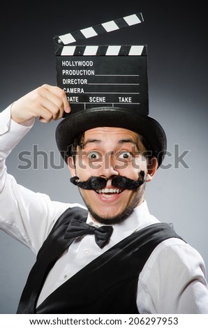 Funny man with movie clapper board 