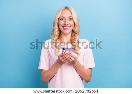 Photo portrait woman smiling happy using smartphone browsing internet isolated pastel blue color background