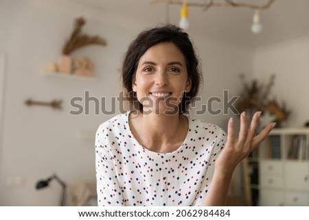 Head shot portrait of happy woman in casual smiling, looking and speaking at camera during video call from home, having job interview talk. Teacher, coach, blogger holding webinar. Screen view Royalty-Free Stock Photo #2062984484