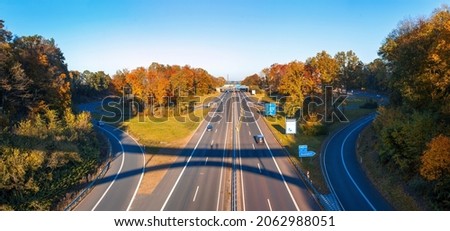View of the German highway in autumn. Multi Lane Autobahn Royalty-Free Stock Photo #2062988051
