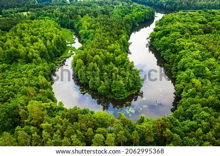 Stunning green forest and river in summer. Aerial view of wildlife in Poland, Europe Royalty-Free Stock Photo #2062995368