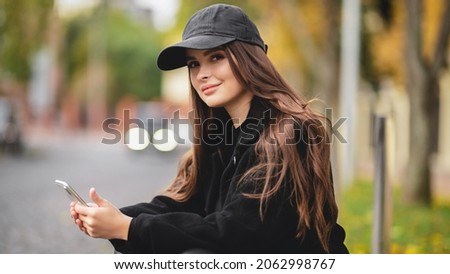 Autumn portrait of an attractive girl in a baseball cap. Autumn shades. Stylish girl Royalty-Free Stock Photo #2062998767