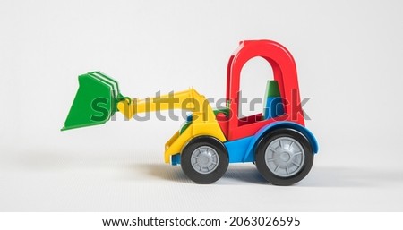 Excavator. Plastic toy multicolored cars isolated on white background.