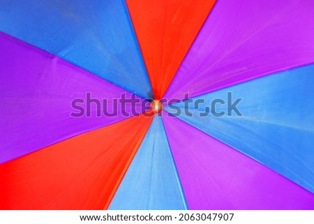 Childrens multicolored umbrella close up background or texture