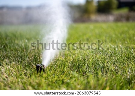 winterizing a irrigation sprinkler system by blowing pressurized air through to clear out water Royalty-Free Stock Photo #2063079545