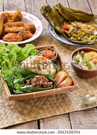 Indonesian lunch menu, nasi tutug oncom  with others. This famous food from West Java, Bandung city. Rice mixed with oncom and spices. Royalty-Free Stock Photo #2063108396