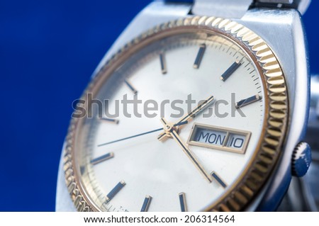 Closeup of classic watch on blue background