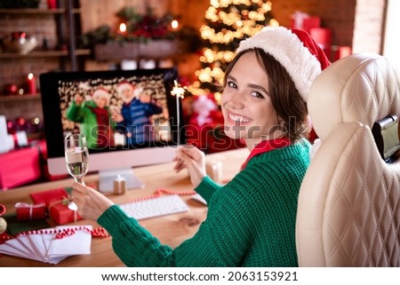 Photo of cheerful lady sit computer drink champagne remote meeting wear hat green sweater in decorated home indoors