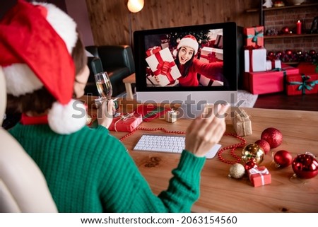 Photo of funny friendly young lady wear knitted pullover headwear looking modern device waving arm indoors room home house Royalty-Free Stock Photo #2063154560