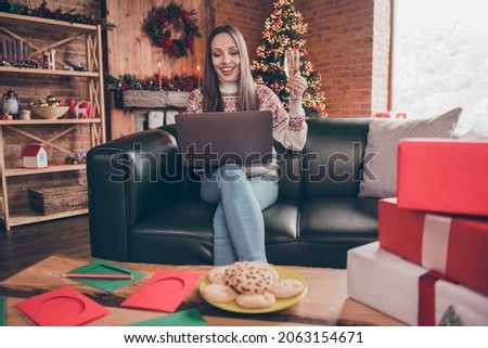 Photo of charming sweet mature woman wear print sweater smiling sending new year congratulations drinking wine indoors house home room Royalty-Free Stock Photo #2063154671