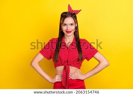Photo of pretty charming young lady wear red outfit arms waist smiling isolated yellow color background