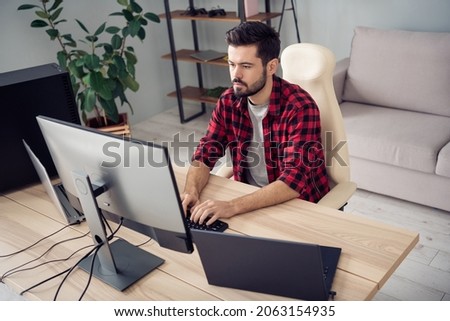 Photo of handsome young man programmer sit desk type code pc screen indoors inside office workplace
