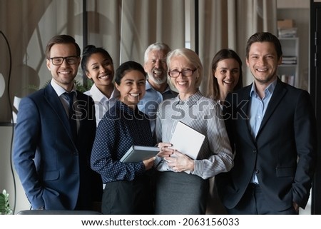 Human resource. Group portrait of smiling employees friendly team of diverse age race gender standing in office together. Successful motivated old young age multiethnic corporate staff look at camera Royalty-Free Stock Photo #2063156033