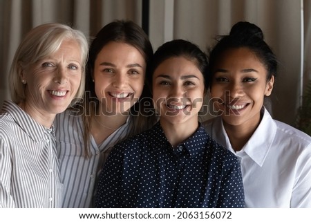 Smiling faces of friendly colleagues. Team portrait of four females coworkers of different age ethnic group. Happy diverse multiethnic women human resource of international company bond look at camera Royalty-Free Stock Photo #2063156072