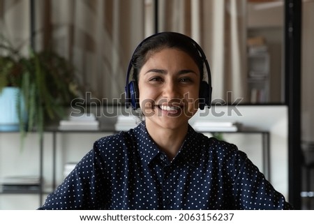 Customer service. Screen view portrait of pleasant young indian woman client support specialist in headset look at web camera. Smiling ethnic lady remote interpreter call center operator do job online