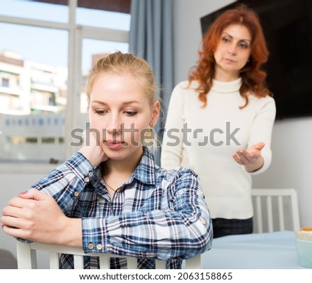 Mature mother soothes adult daughter. High quality photo