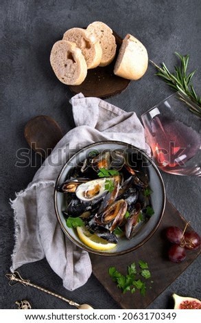 Mussels with snacks on dark background. Top view, flat lay, copy space