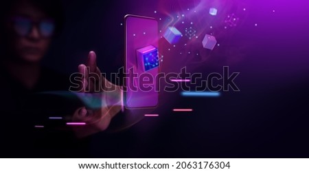Metaverse and Blockchain Technology Concepts. Person with an Experiences of Metaverse Virtual World via Smart Phone. Futuristic Tone. Conceptual Photo Royalty-Free Stock Photo #2063176304