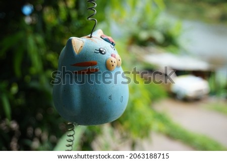 cute blue cat mobile is hanging by the spring